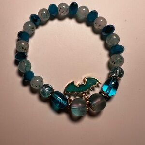 Elegant Blue and Gold Beaded Bracelet With Bat Charm